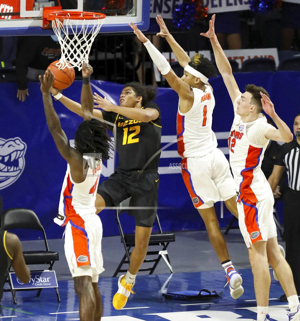 Brad Mcclenny Missouri guard Dru Smith (12) goes up and under the basket to score the game winning basket against Florida during an NCAA college basketball game, Wednesday, March 3, 2021 in Gainesville, Fla. (Brad McClenny/The Gainesville Sun via AP)