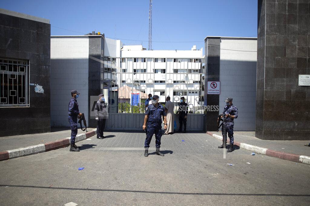 Khalil Hamra Hamas police officers guard the entrance of the Shifa Hospital after coronavirus cases were discovered in the hospital, in Gaza City, Wednesday, Aug. 26, 2020. Gaza health officials have reported the first death from COVID-19 since authorities detected the first local cases of the coronavirus earlier this week. (AP Photo/Khalil Hamra)