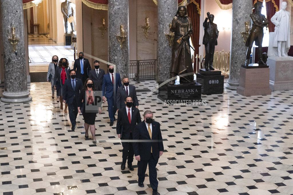 Manuel Balce Ceneta Acting Sergeant at Arms Timothy Blodgett, bottom right, leads Rep. Jamie Raskin, D-Md., the lead Democratic House impeachment manager, Rep. David Cicilline, D-R.I., Rep. Diana DeGette, D-Colo., Rep. Joaquin Castro, D-Texas, Rep. Eric Swalwell, D-Calif., Rep. Ted Lieu, D-Calif., Delegate Tacey Plaskett, D-V.I., Rep. Madeleine Dean, D-Pa., and Rep. Joe Neguse, D-Colo., through Statuary Hall to the Senate for the second impeachment trial of former President Donald Trump, Tuesday, Feb. 9, 2021, in Washington. (AP Photo/Manuel Balce Ceneta)