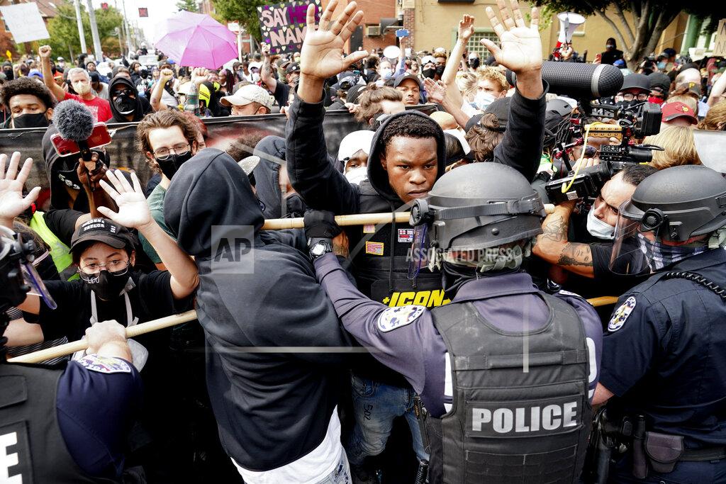 John Minchillo FILE - Police and protesters converge during a demonstration on Sept. 23, 2020, in Louisville, Ky. Louisville activists who put in long hours protesting the death of Breonna Taylor say they felt relief this week when federal officials charged four officers on Thursday, Aug. 4, 2022. The indictments represent the first time Louisville police officers have been held accountable for Taylor’s shooting death in her home. Most of the new charges center around the faulty warrant that led officers to Taylor’s front door. (AP Photo/John Minchillo, File)