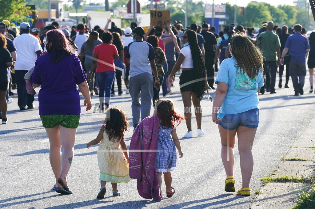 Steve Helber Two children with their moms follow a protest of the shooting of Andrew Brown Jr. along the streets of Elizabeth City, N.C., Wednesday, April 28, 2021. A judge has denied requests to release body camera video in the case of Brown, a Black man who was killed by North Carolina deputies. (AP Photo/Steve Helber)