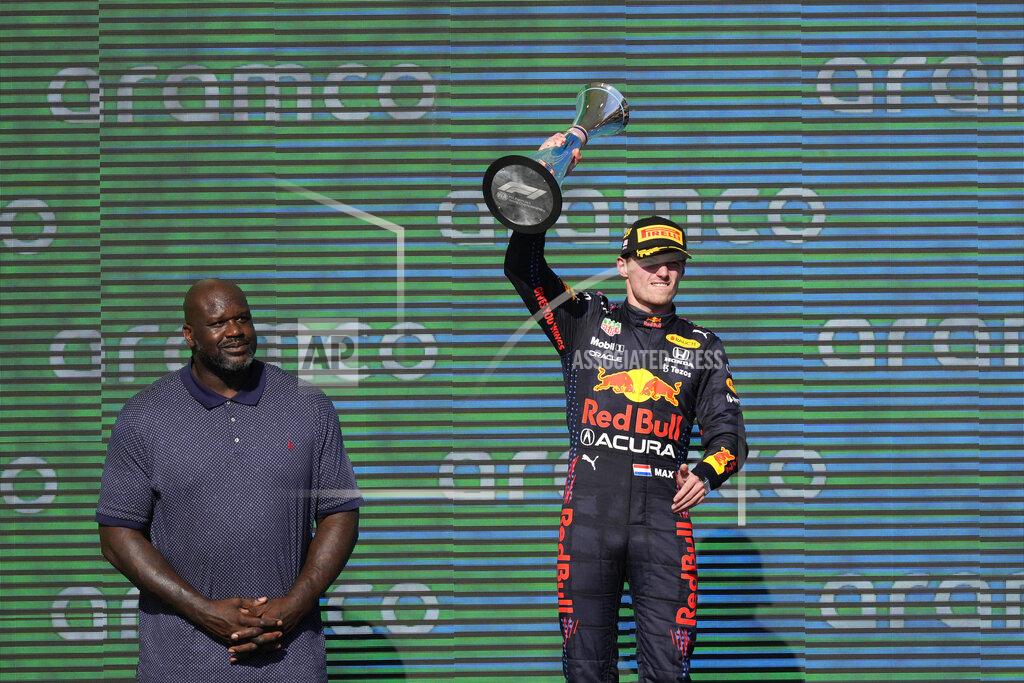 Nick Didlick Red Bull driver Max Verstappen, right, of the Netherlands, holds up the winner's trophy as Shaquille O'Neal looks on at the Formula One U.S. Grand Prix auto race at Circuit of the Americas, Sunday, Oct. 24, 2021, in Austin, Texas. (AP Photo/Nick Didlick)