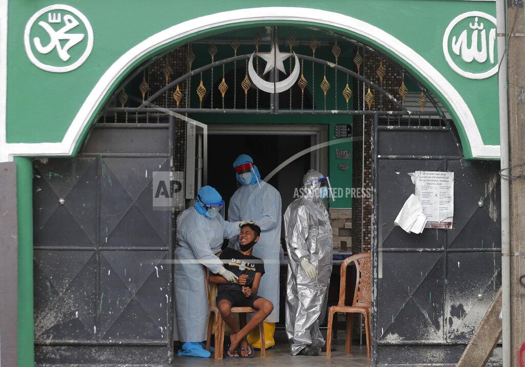 Eranga Jayawardena A Sri Lankan boy reacts as health officials take his nasal swab sample to test for COVID-19 outside a mosque in Colombo, Sri Lanka, Monday, Dec. 21, 2020. (AP Photo/Eranga Jayawardena)
