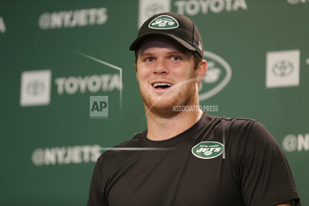 In this May 23, 2019 file photo New York Jets quarterback Sam Darnold speaks to reporters after the NFL football team's practice in Florham Park, N.J. The New York Jets have put last year’s disappointing 4-12 record far behind them and a new-look roster has them feeling positive about this upcoming season. Darnold said, Wednesday, July 24, 2019, there’s a sense that the whole franchise has experienced a rebirth because of the good vibes around the building. (AP Photo/Seth Wenig, file)
