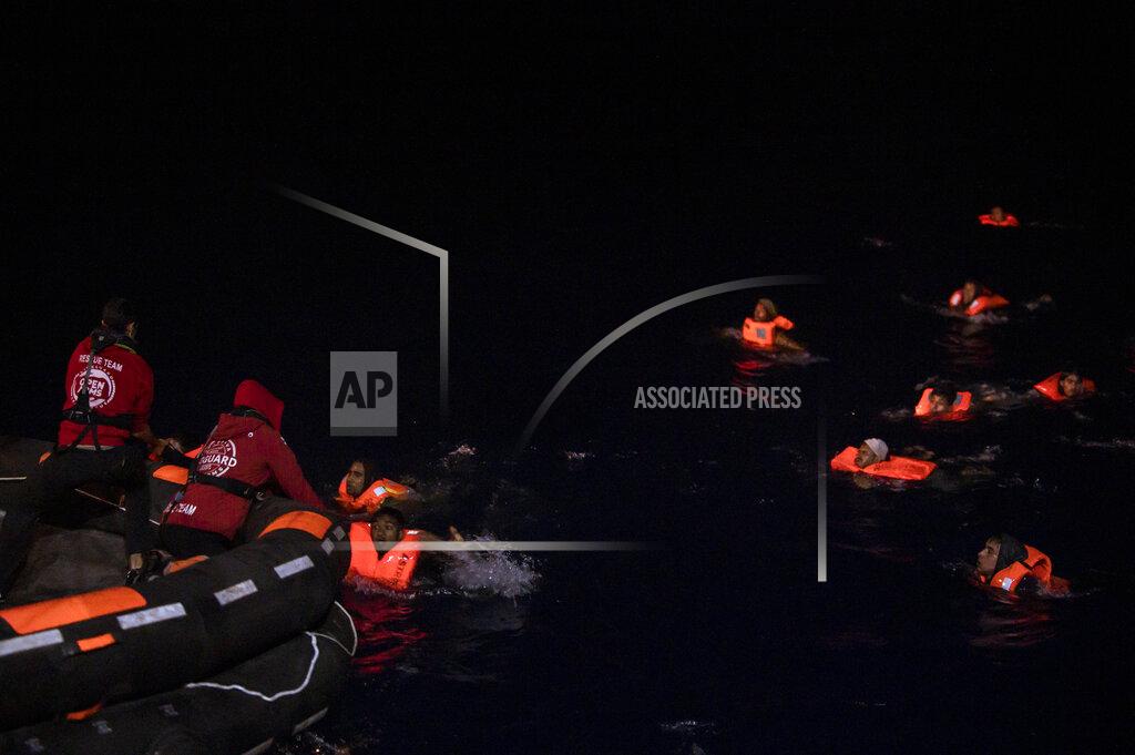 Valeria Ferrario Dozens of migrants swim toward rescuers after their boat upturned off the waters of Tunisia early Wednesday, May 25, 2022. Some 110 people were rescued by the non-governmental organization Open Arms during a mission in the Mediterranean Sea. (AP Photo/Valeria Ferraro)