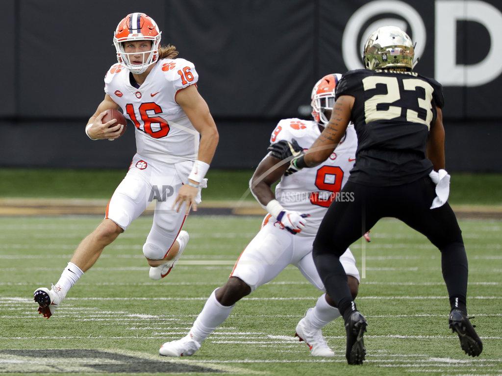 Chuck Burton Clemson's Trevor Lawrence (16) scrambles as Wake Forest's Justin Strnad (23) defends during the first half of an NCAA college football game in Charlotte, N.C., Saturday, Oct. 6, 2018. (AP Photo/Chuck Burton)