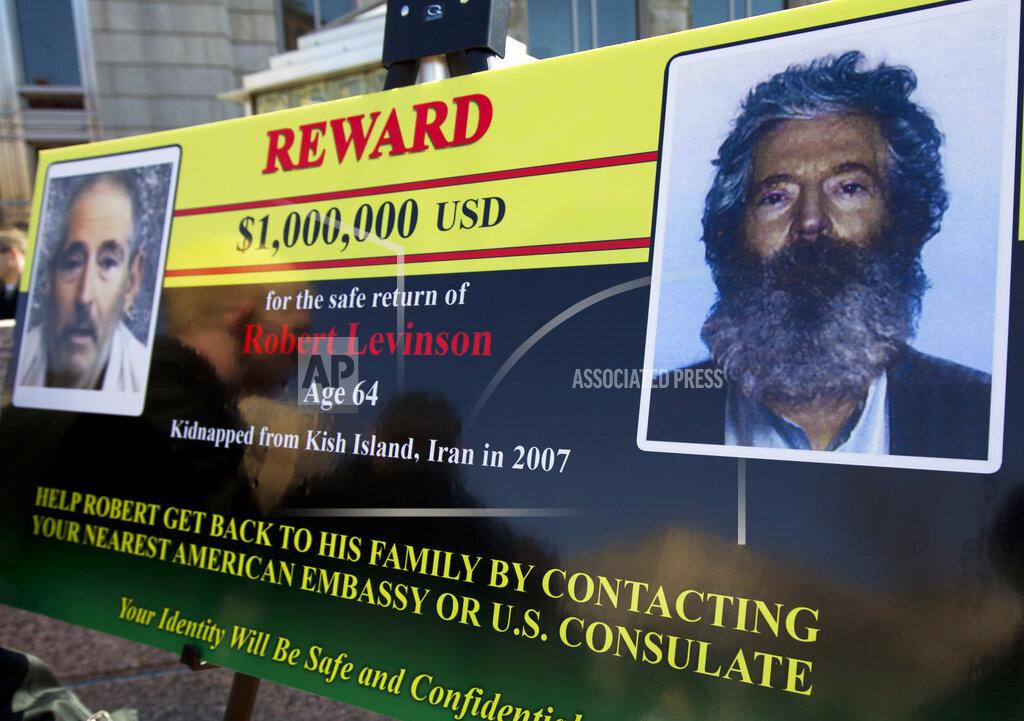 FILE - In this March 6, 2012 file photo, an FBI poster showing a composite image of former FBI agent Robert Levinson, right, of how he would look like now, left, taken from the video, released by his captors in Washington during a news conference. The family of retired FBI agent Levinson said Wednesday, March 25, 2020, that U.S. government officials have concluded that he has died while in the custody of Iran. (AP Photo/Manuel Balce Ceneta, File)