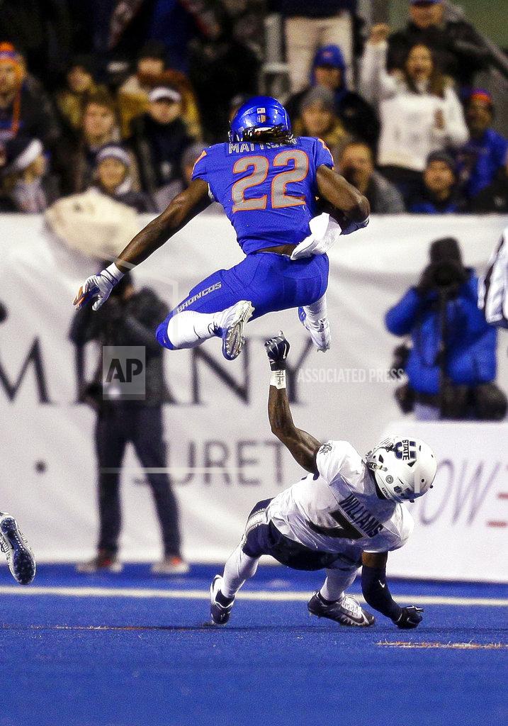 Steve Conner Boise State running back Alexander Mattison (22) hurdles Utah State cornerback DJ Williams (7) during the first half of an NCAA college football game Saturday, Nov. 24, 2018, in Boise, Idaho. (AP Photo/Steve Conner)