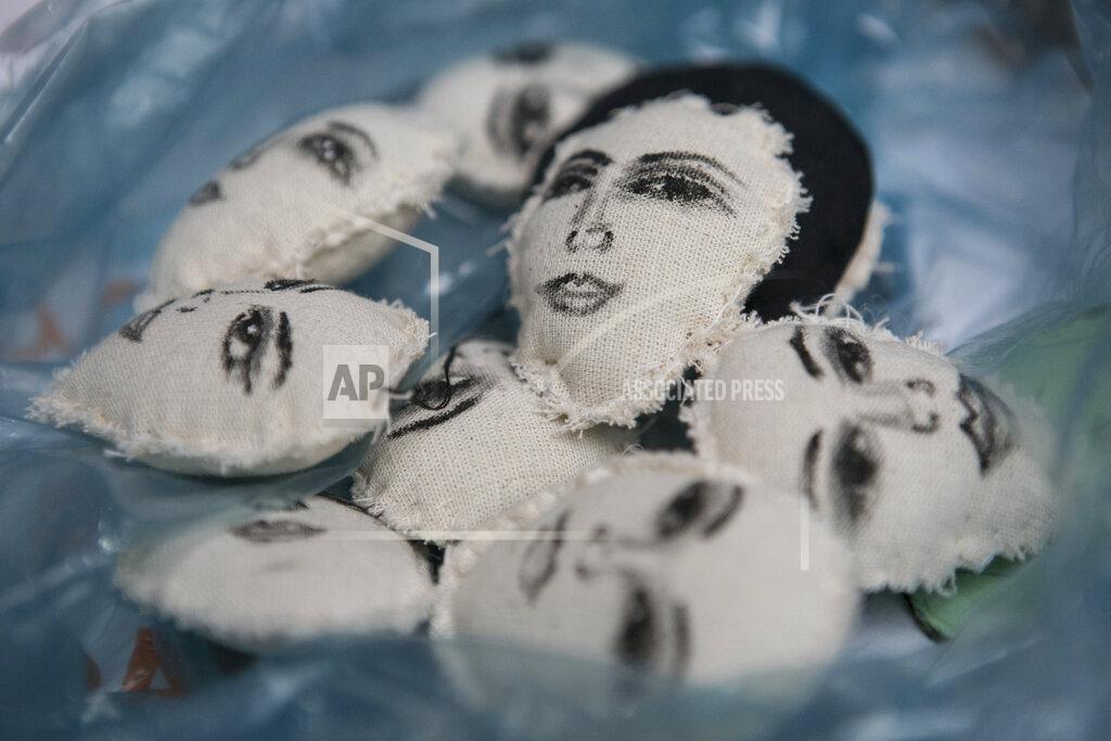 Ginnette Riquelme The hand-painted faces of women decorate small pillows before being made into key rings by Erika Martinez, which she sells to raise money while living with her daughter inside Mexico’s Human Rights Commission (CNDH) office, which has been converted into a refuge for victims of gender violence like Martinez and her daughter, after women’s rights activists occupied it three months ago months in Mexico City, Tuesday, Nov. 17, 2020. Martinez, who said she suffered sexual abuse when she was 10-years-old but was never reported by her parents, started selling doll faces last year and since then they have come to identify their carriers as supportive of feminism. Martinez said her daughter also became a victim of sexual abuse by her brother-in-law three years ago when her daughter was just 7, but that her attacker remains free despite, her reporting it to authorities. (AP Photo/Ginnette Riquelme)