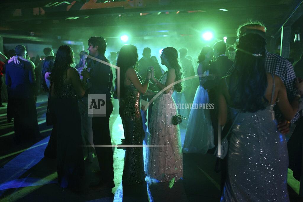 Paul Ratje Young people dance during prom at the Grace Gardens Event Center in El Paso, Texas on Friday, May 7, 2021. Around 2,000 attended the outdoor event at the private venue after local school districts announced they would not host proms this year. Tickets cost $45. (AP Photo/Paul Ratje)
