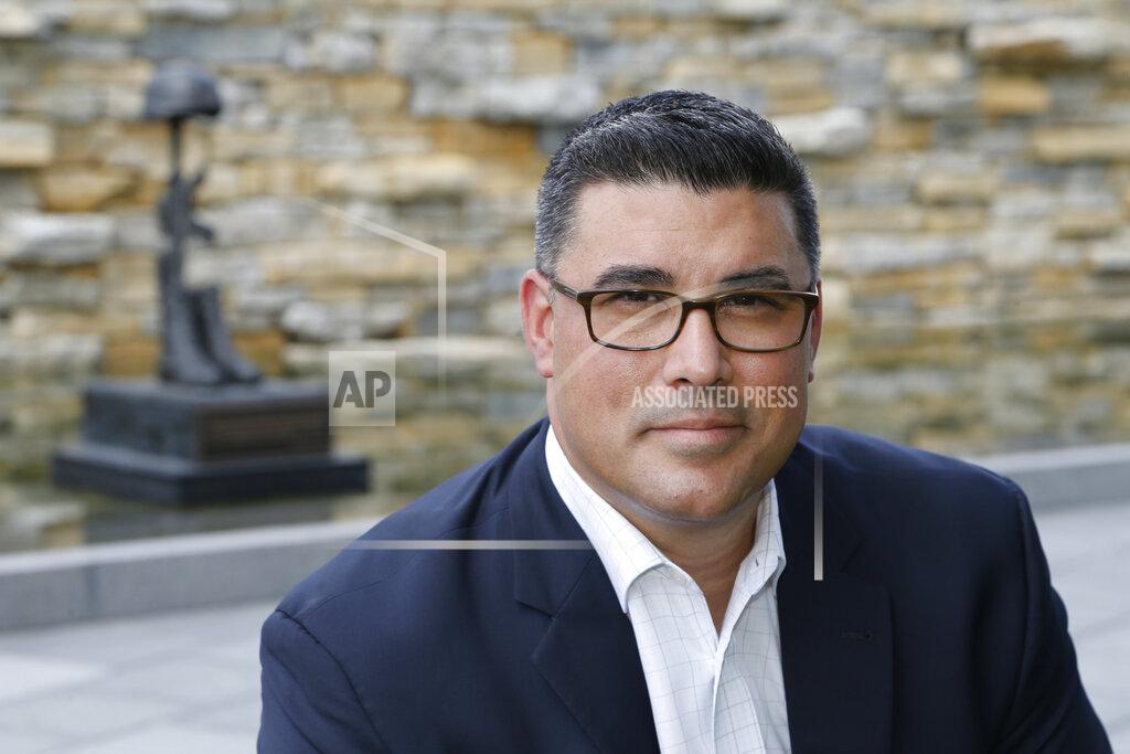 Jay Laprete In this photo made on July 31, 2020, Jason Dominguez poses for a photo at the National Veterans Memorial and Museum, in Columbus, Ohio. was a Marine that was in the Columbus, Ohio-based Lima Company that served in Iraq, when the vehicle immediately behind his in a convoy was blown up by a roadside bomb Aug. 3, 2005, killing 15. Some survivors and families of those killed had planned a 15-year reunion this weekend, but it had to be canceled amid restrictions for the COVID-19 pandemic. (AP Photo/Jay LaPrete)