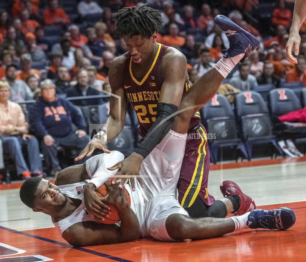 Rick Danzl Illinois forward Kipper Nichols grabs a loose ball next to Minnesota center Daniel Oturu (25) during the second half of an NCAA college basketball game in Champaign, Ill., Wednesday, Jan. 16, 2019. (AP Photo/Rick Danzl)