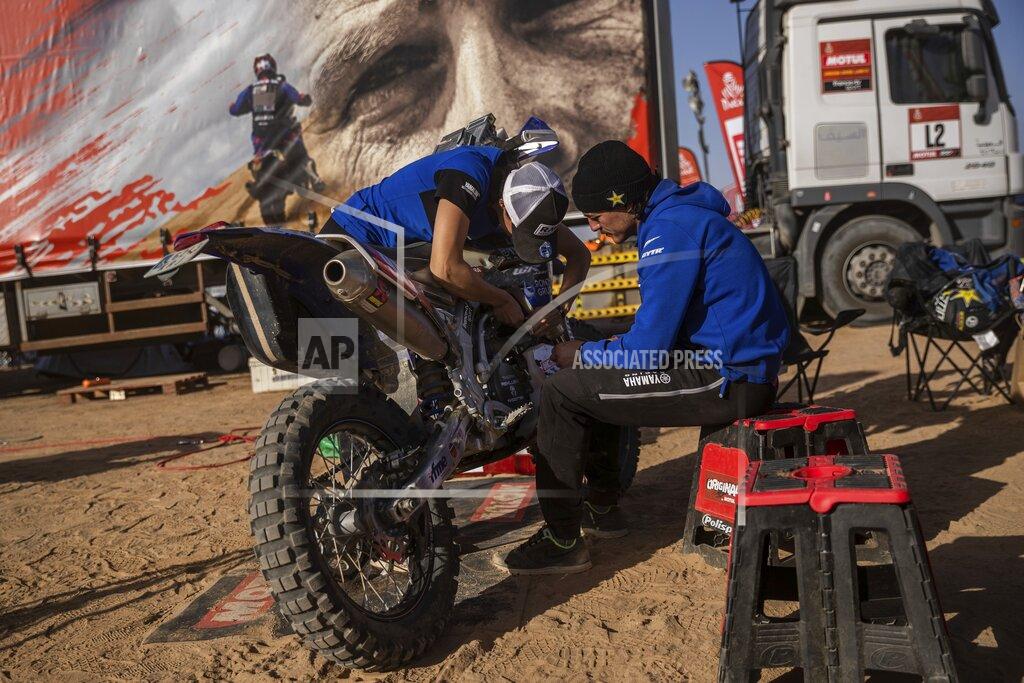Bernat Armangue In this Monday, Jan. 13, 2020 photo, Sara Garcia of Spain checks her Yamaha motorbike, next to his partner Javier Vega of Spain at the Dakar rally "park ferme" in Wadi Al Dawasir, Saudi Arabia. Formerly known as the Paris-Dakar Rally, the race was created by Thierry Sabine after he got lost in the Libyan desert in 1977. Until 2008, the rallies raced across Africa, but threats in Mauritania led organizers to cancel that year's event and move it to South America. It has now shifted to Saudi Arabia. The race started on Jan. 5 with 560 drivers and co-drivers, some on motorbikes, others in cars or in trucks. Only 41 are taking part in the Original category. (AP Photo/Bernat Armangue)