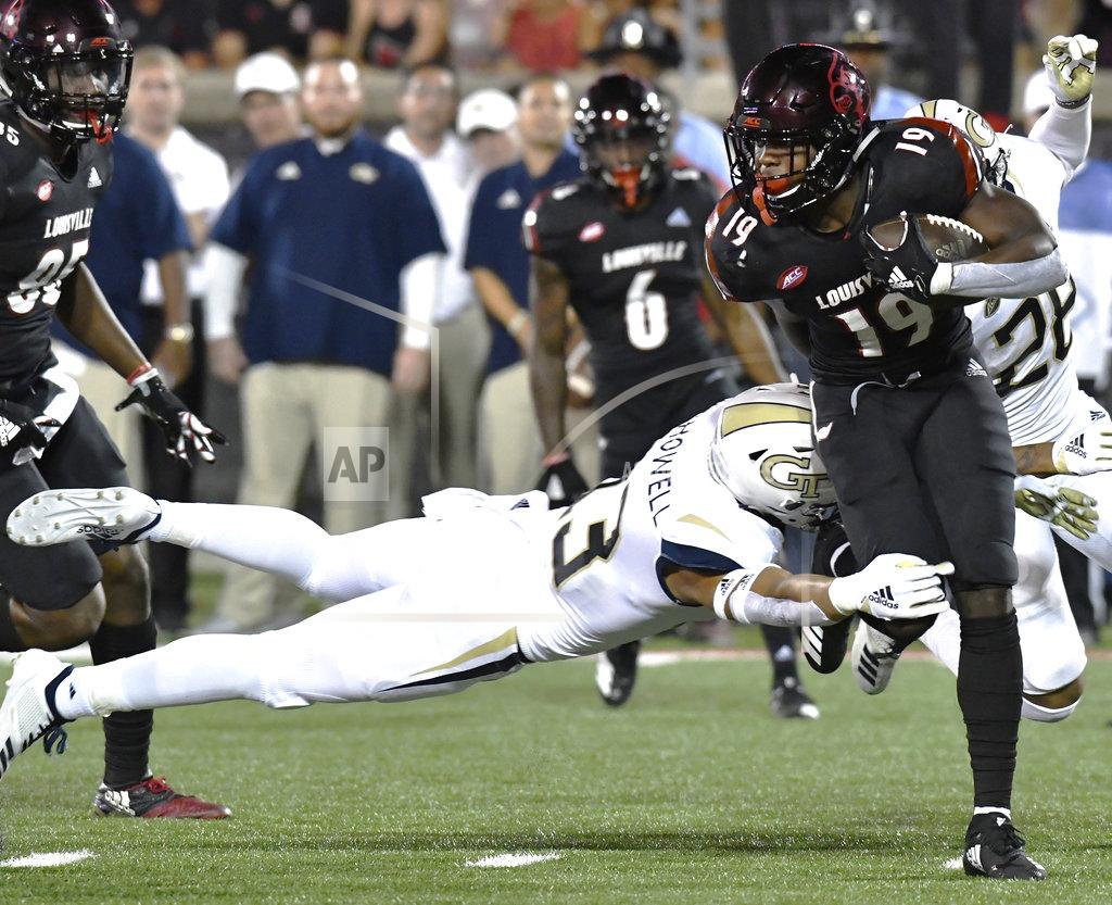 Timothy D. Easley Georgia Tech defensive back Avery Showell (13) attempts a diving tackle on Louisville running back Hassan Hall (19) during the second half of an NCAA college football game, Friday, Oct. 5, 2018, in Louisville, Ky. Georgia Tech won 66-31. (AP Photo/Timothy D. Easley)
