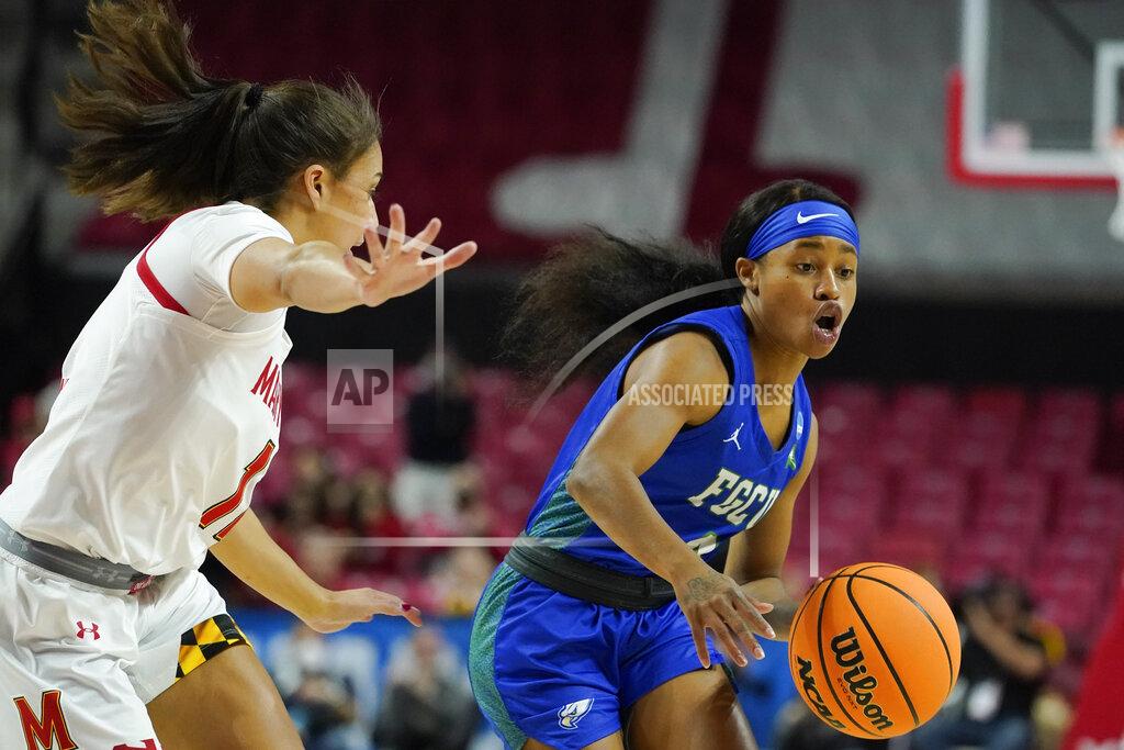 Julio Cortez Florida Gulf Coast guard Tishara Morehouse, right, drives against Maryland guard Katie Benzan during the first half of a college basketball game in the second round of the NCAA tournament, Sunday, March 20, 2022, in College Park, Md. (AP Photo/Julio Cortez)