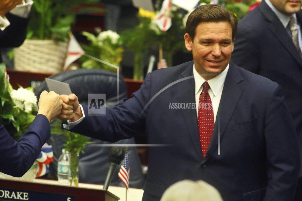 Phil Sears Florida Gov. Ron DeSantis fist bumps with legislators Tuesday, March 2, 2021, as he enters the House of Representatives prior to his State of the State address at the Capitol in Tallahassee, Fla. (AP Photo/Phil Sears)