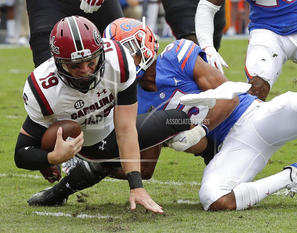 John Raoux South Carolina quarterback Jake Bentley (19) is stopped by Florida defensive back CJ Henderson, right, during the first half of an NCAA college football game, Saturday, Nov. 10, 2018, in Gainesville, Fla. (AP Photo/John Raoux)