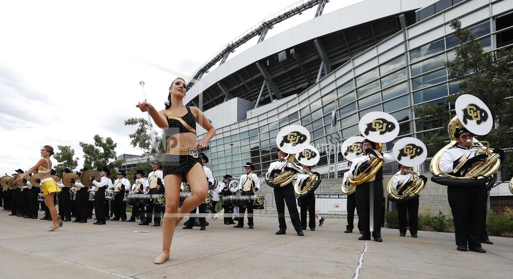 David Zalubowski Baton-twirlers perform along with the Colorado marching band outside the stadium before Colorado faces Colorado State in an NCAA college football game Friday, Aug. 31, 2018, in Denver. (AP Photo/David Zalubowski)