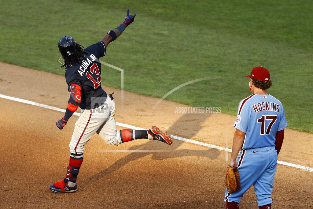 Matt Slocum Atlanta Braves' Ronald Acuna Jr., left, reacts past Philadelphia Phillies first baseman Rhys Hoskins after hitting a two-run home run off relief pitcher Trevor Kelley during the sixth inning of the second baseball game in a doubleheader, Sunday, Aug. 9, 2020, in Philadelphia. (AP Photo/Matt Slocum)