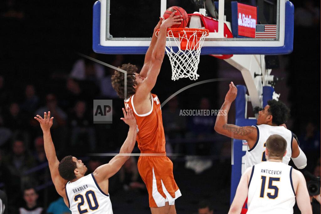 Kathy Willens Texas forward Jericho Sims (20) dunks as California guard Matt Bradley (20) and California forward Grant Anticevich (15) watch from the floor during the first half of an NCAA college basketball game in the 2K Empire Classic, Friday, Nov. 22, 2019, in New York. (AP Photo/Kathy Willens)