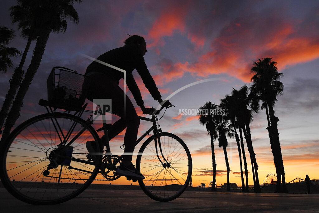 Mark J. Terrill A cyclist rides on Santa Monica State Beach, Friday, April 10, 2020, in Santa Monica, Calif. (AP Photo/Mark J. Terrill)
