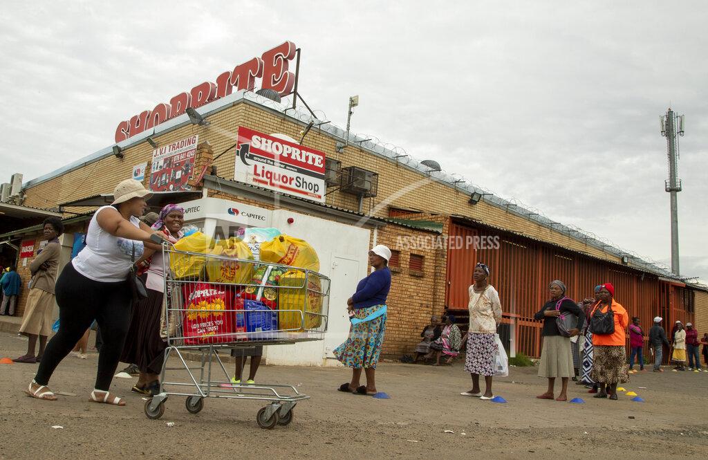 Themba Hadebe A woman and her mother, push a shopping trolley through the carpark at a supermarket at a social grant pay point in Thokoza, east of Johannesburg, South Africa, Monday, March 30, 2020, as South Africa continued it's nationwide lockdown for 21 days in an effort to control the spread of the coronavirus. The virus causes mild or moderate symptoms for most people, but for some, especially older adults and people with existing health problems, it can cause more severe illness or death. (AP Photo/Themba Hadebe)