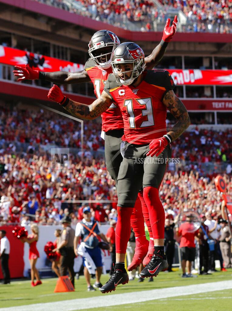 Mark Lomoglio Tampa Bay Buccaneers wide receiver Mike Evans (13) celebrates his touchdown against the New York Giants with wide receiver Chris Godwin (12) during the first half of an NFL football game Sunday, Sept. 22, 2019, in Tampa, Fla. (AP Photo/Mark LoMoglio)