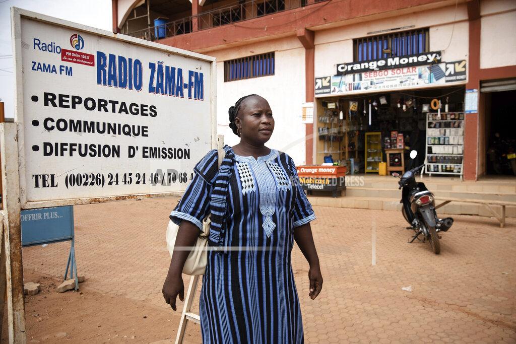 Sophie Garcia Mariama Sawadogo, 44, poses outside Zama Radio where she works as a radio host in Kaya, Burkina Faso, Monday, Oct. 25, 2021. Sawadogo's voice has become a familiar sound for nearly a million people in her town of Kaya and beyond. In the West African country of Burkina Faso, many feel the government has let them down during the pandemic. Tests, vaccines and messaging often miss many residents, despite a $200 million budget for virus-response efforts. In a region where women are responsible for family work and community relationships, they’ve stepped up to fill in gaps. (AP Photo/Sophie Garcia)