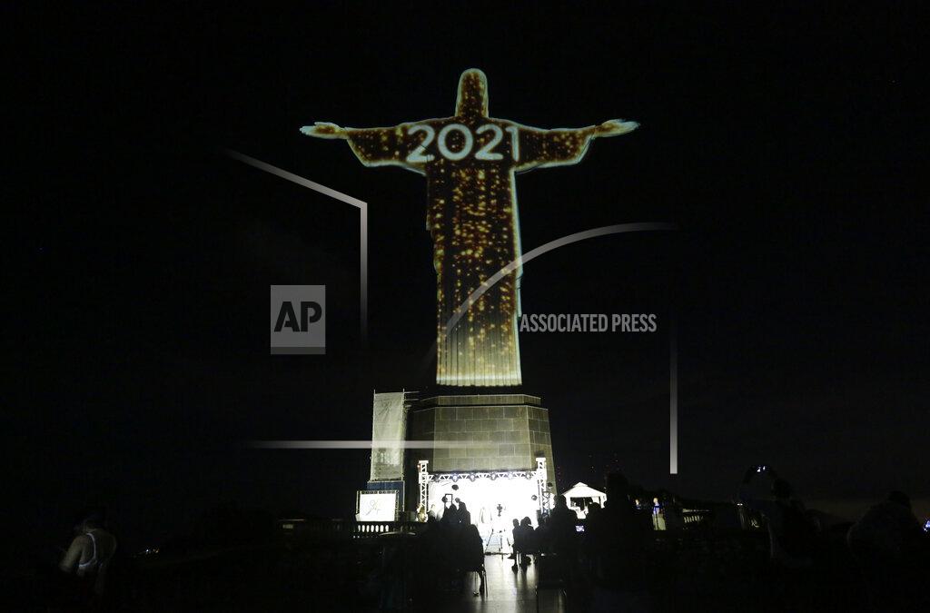 Bruna Prado The iconic Christ the Redeemer statue is lit up during a New Year's Eve celebration in Rio de Janeiro, Brazil, Thursday, Dec. 31, 2020. (AP Photo/Bruna Prado)