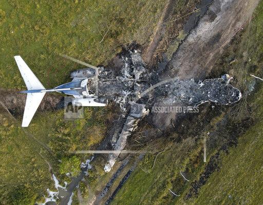 The remnants of an aircraft, which caught fire soon after a failed take-off attempt at Houston Executive Airport, are seen just north of Morton Road on Tuesday, Oct. 19, 2021, in Brookshire. Texas. (Godofredo A. Vásquez/Houston Chronicle via AP)