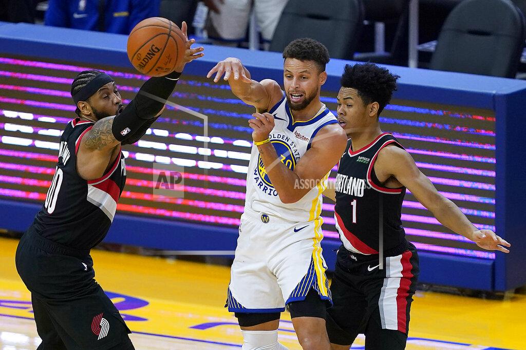 Tony Avelar Golden State Warriors guard Stephen Curry (30) passes the ball between Portland Trail Blazers forward Carmelo Anthony (00) and guard Anfernee Simons (1) during the first half of an NBA basketball game in San Francisco, Friday, Jan. 1, 2021. (AP Photo/Tony Avelar)