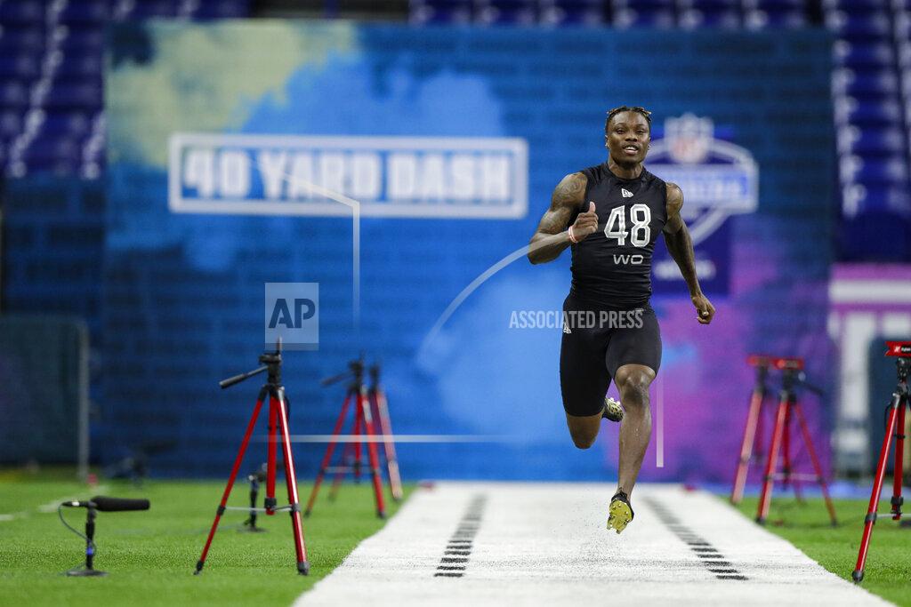 Alabama wide receiver Henry Ruggs III runs the 40-yard dash at the NFL football scouting combine in Indianapolis, Thursday, Feb. 27, 2020. (AP Photo/Michael Conroy)
