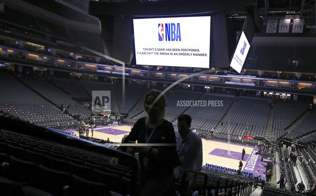 Rich Pedroncelli Fans leave the Golden 1 Center after the NBA basketball game between the New Orleans Pelicans and Sacramento Kings was postponed at the last minute in Sacramento, Calif., Wednesday, March 11, 2020. The league said the decision was made out of an "abundance of caution," because official Courtney Kirkland, who was scheduled to work the game, had worked the Utah Jazz game earlier in the week. A player for the Jazz tested positive for the coronavirus. (AP Photo/Rich Pedroncelli)