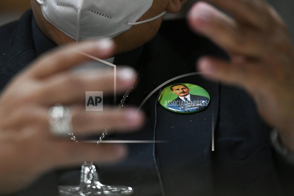 Matias Delacroix Monsignor Tulio Ramirez wears a pin of the late Dr. Jose Gregorio Hernandez during an interview about Hernandez's beatification in Caracas, Venezuela, Tuesday, April 27, 2021. Known as the "doctor of the poor," Hernandez is set to be beatified by the Catholic church, a step towards sainthood, on April 30th. (AP Photo/Matias Delacroix)