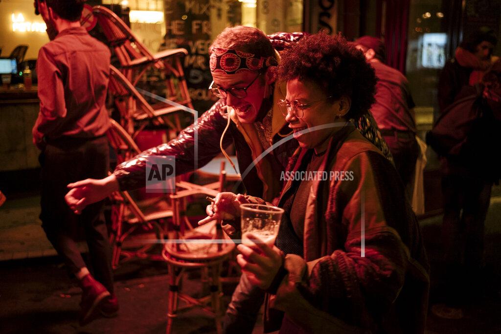 Lewis Joly People enjoy a drink and dance on a bar terrace in Paris, Monday, Oct.5, 2020. French authorities have placed the Paris region on maximum virus alert on Monday, banning festive gatherings and requiring all bars to close but allowing restaurants to remain open, as numbers of infections are rapidly increasing. (AP Photo/Lewis Joly)