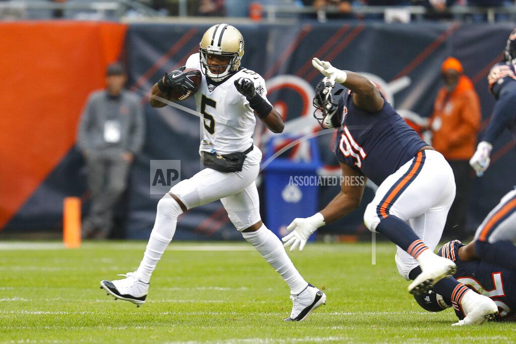 Charles Rex Arbogast New Orleans Saints quarterback Teddy Bridgewater (5) is chased by Chicago Bears nose tackle Eddie Goldman (91) during the first half of an NFL football game in Chicago, Sunday, Oct. 20, 2019. (AP Photo/Charles Rex Arbogast)