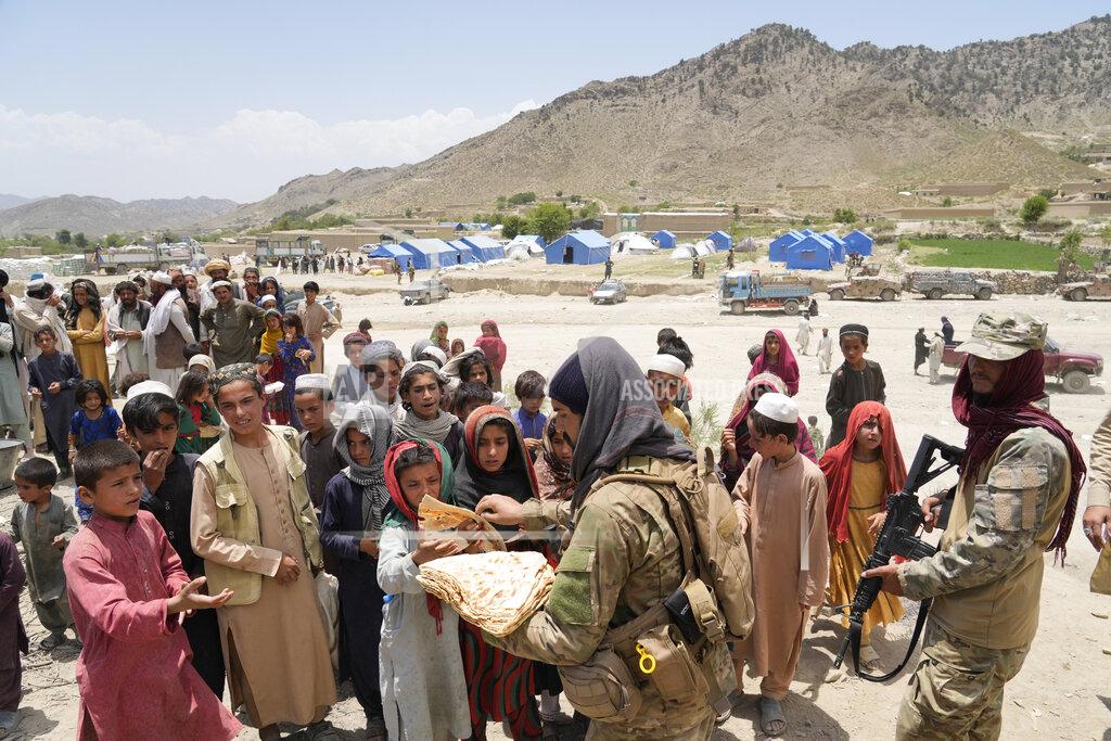 Ebrahim Noroozi Afghans receive aid at a camp after an earthquake in Gayan district in Paktika province, Afghanistan, Sunday, June 26, 2022. A powerful earthquake struck a rugged, mountainous region of eastern Afghanistan early Wednesday, flattening stone and mud-brick homes in the country's deadliest quake in two decades, the state-run news agency reported. (AP Photo/Ebrahim Nooroozi)