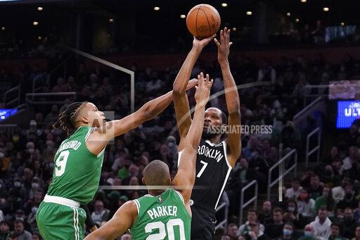 Brooklyn Nets forward Kevin Durant (7) shoots while covered by Boston Celtics guard Romeo Langford (9) and forward Jabari Parker (20) during the second half of an NBA basketball game, Wednesday, Nov. 24, 2021, in Boston. (AP Photo/Charles Krupa)