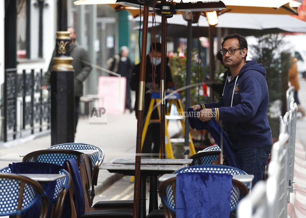 Alastair Grant Blankets and heaters are made ready as preparations get underway in the Soho area of London, Monday, April 12, 2021, as restaurants, bars and pubs can open and serve people who can be seated outside. Millions of people in England will get their first chance in months for haircuts, casual shopping and restaurant meals on Monday, as the government takes the next step on its coronavirus lockdown-lifting road map. (AP Photo/Alastair Grant)
