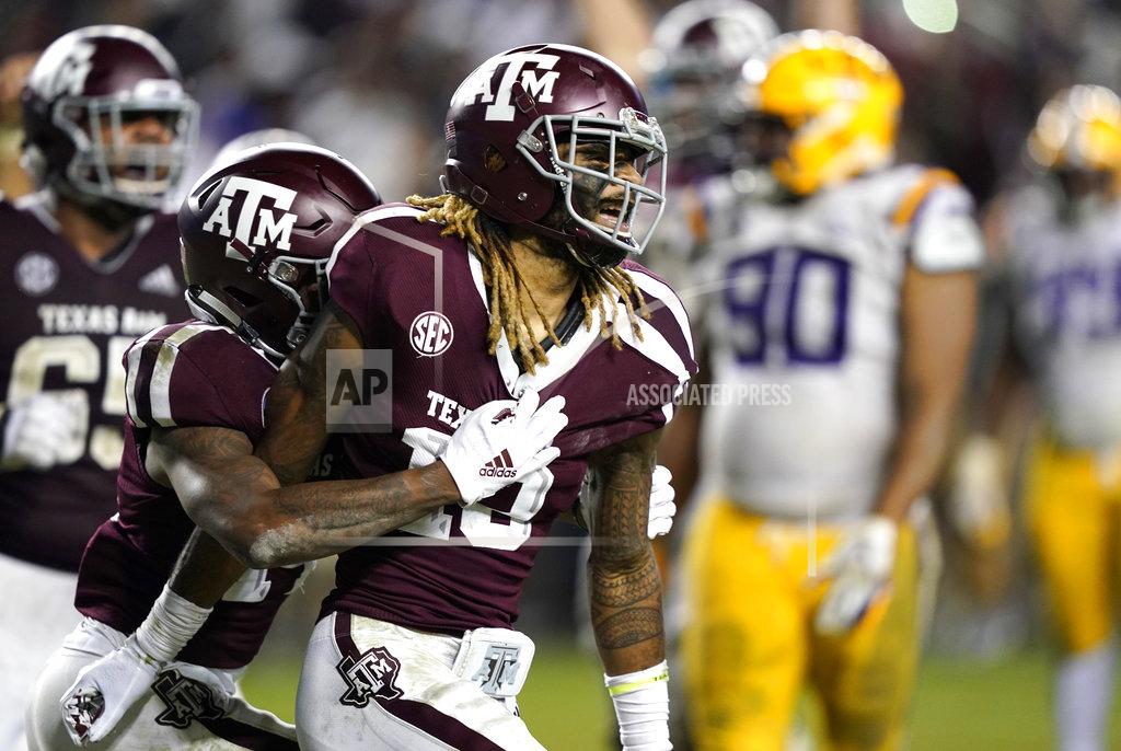 David J. Phillip Texas A&M wide receiver Kendrick Rogers, right, celebrates with Camron Buckley after catching a pass for a two-point conversion during the seventh overtime to beat LSU in an NCAA college football game Saturday, Nov. 24, 2018, in College Station, Texas. Texas A&M won 74-72. (AP Photo/David J. Phillip)