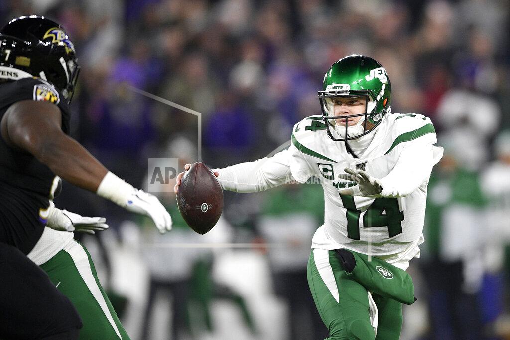 Nick Wass New York Jets quarterback Sam Darnold (14) tries to run away from Baltimore Ravens defensive tackle Michael Pierce, left, during the first half of an NFL football game, Thursday, Dec. 12, 2019, in Baltimore. (AP Photo/Nick Wass)