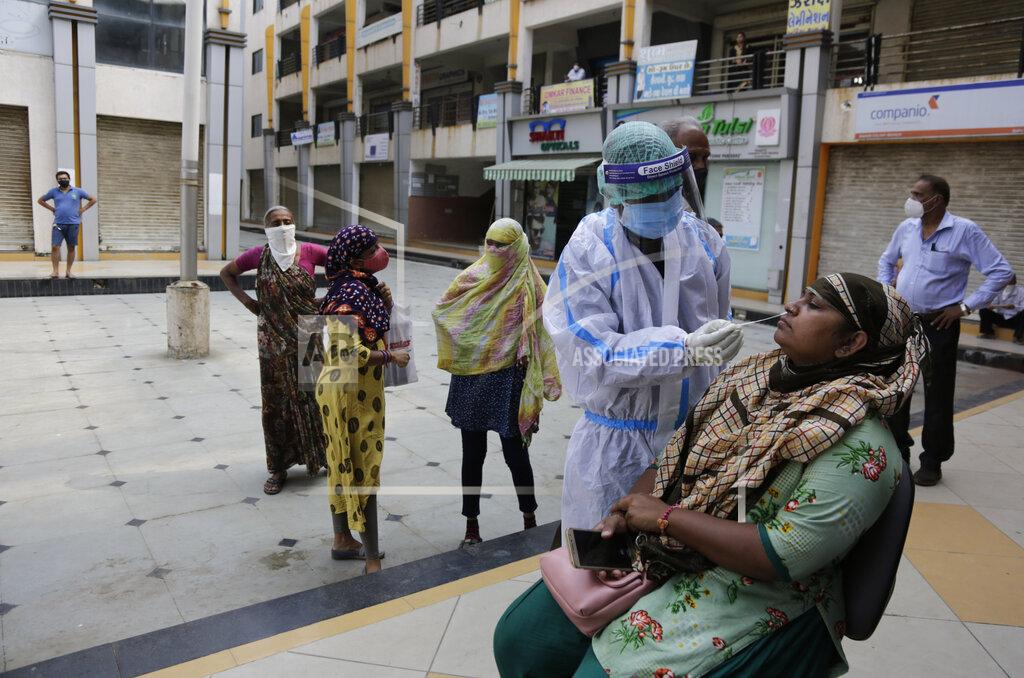 Ajit Solanki A health worker takes a nasal swab sample to test for COVID-19 outside a bank in Ahmedabad, India, Thursday, Sept. 10, 2020. India's coronavirus cases are now the second-highest in the world and only behind the United States. (AP Photo/Ajit Solanki)