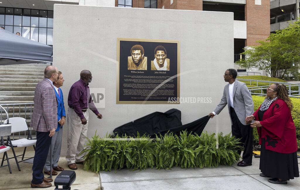 Vasha Hunt Wilbur Jackson, left and John Mitchell pull the drapes at the John Mitchell and Wilbur Jackson Commemorative Plaque Unveiling before Alabama's A-Day NCAA college football scrimmage, Saturday, April 16, 2022, in Tuscaloosa, Ala. Also at left is Alabama president star Bell and Alabama head coach Nick Saban, while at right is Christine Taylor, vice president and associate provost for diversity, equity and inclusion. (AP Photo/Vasha Hunt)
