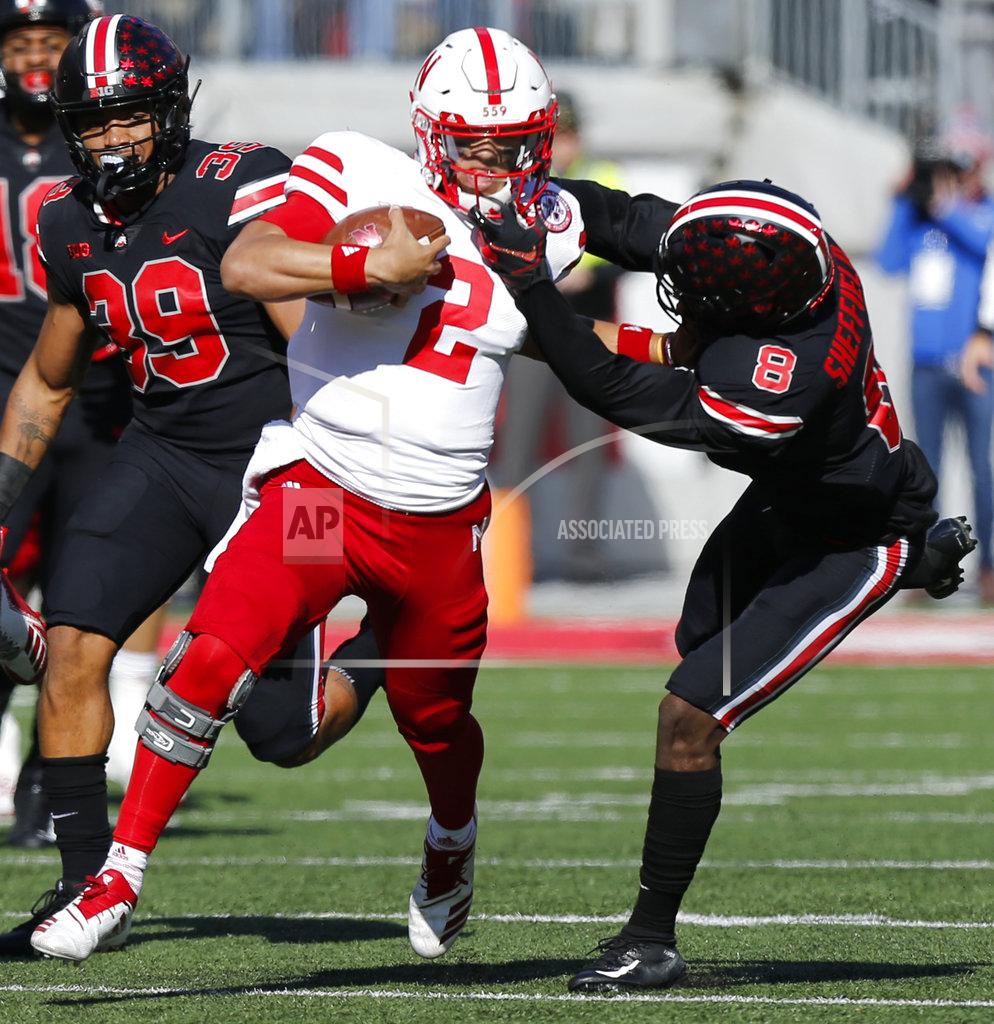 Jay Laprete Ohio State defensive back Kendall Sheffield, right, grabs the face mask of Nebraska quarterback Adrian Martinez during the first half of an NCAA college football game Saturday, Nov. 3, 2018, in Columbus, Ohio. (AP Photo/Jay LaPrete)