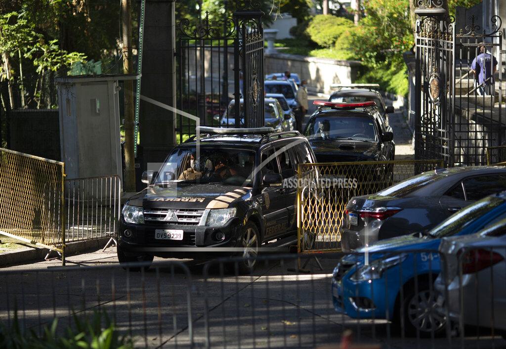 Silvia Izquierdo Federal police leave Laranjeiras Palace, the official residence of Rio de Janeiro Gov. Wilson Witzel, in Rio de Janeiro, Brazil, Tuesday, May 26, 2020. Brazil's Federal Police raided the governor's official residence on Tuesday to carry out searches, part of an investigation into the embezzlement of public resources in the state's response to the COVID-19 pandemic. (AP Photo/Silvia Izquierdo)