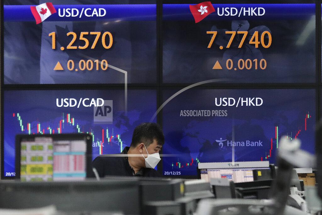 A currency trader watches monitors at the foreign exchange dealing room of the KEB Hana Bank headquarters in Seoul, South Korea, Thursday, April 1, 2021. Asian stock markets followed Wall Street higher Thursday after Japan and South Korea reported unexpectedly strong economic data and President Joe Biden announced a $2.3 trillion U.S. infrastructure spending plan. (AP Photo/Ahn Young-joon)