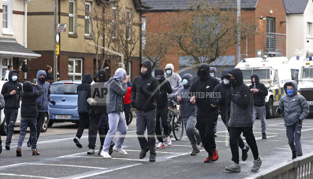 Peter Morrison Nationalist youths turn away after confronting a police line blocking a road near the Peace Wall in West Belfast, Northern Ireland, Thursday, April 8, 2021. Authorities in Northern Ireland sought to restore calm Thursday after Protestant and Catholic youths in Belfast hurled bricks, fireworks and gasoline bombs at police and each other. It was the worst mayhem in a week of street violence in the region, where Britain's exit from the European Union has unsettled an uneasy political balance. (AP Photo/Peter Morrison)