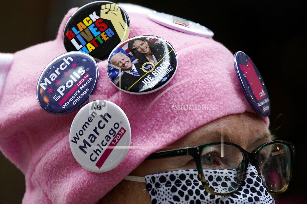 Nam Y. Huh A woman wears a hat with button badges as she attends the Women's March in downtown Chicago, Saturday, Oct. 17, 2020. Dozens of Women's March rallies were planned from New York to San Francisco to signal opposition to President Donald Trump and his policies, including the push to fill the seat of late Supreme Court Justice Ruth Bader Ginsburg before Election Day. (AP Photo/Nam Y. Huh)
