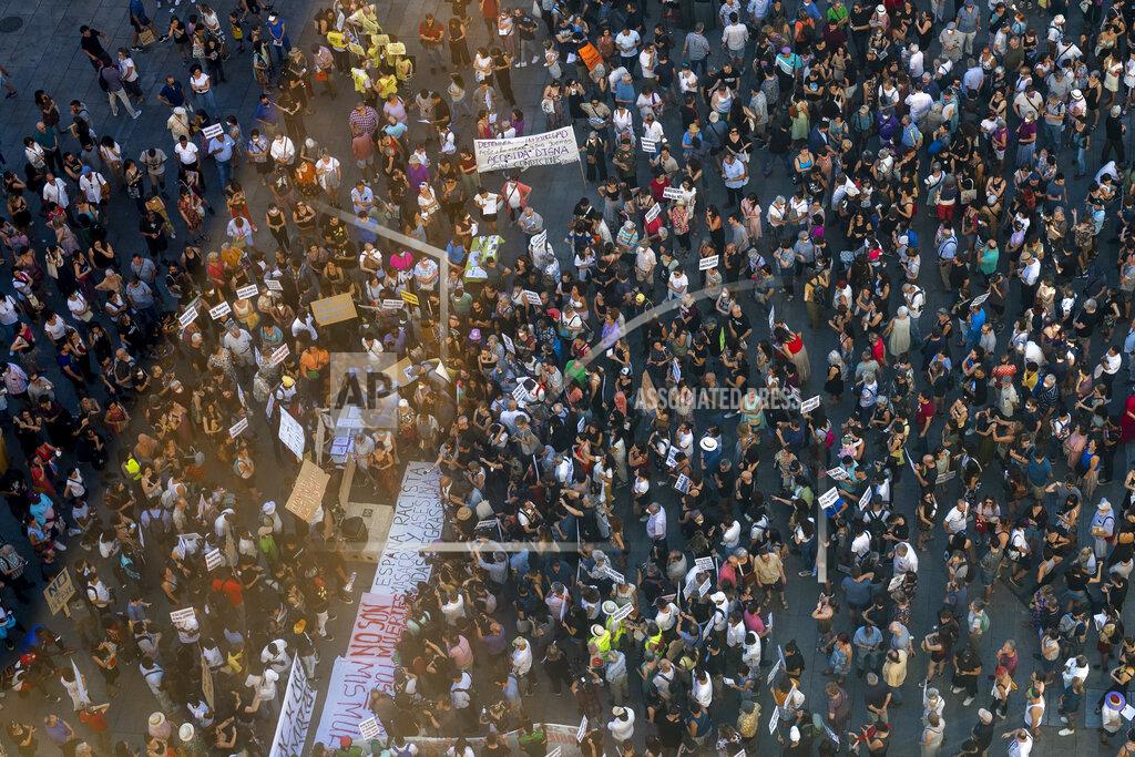 Manu Fernandez People gather during a protest over the deaths of at least 23 people at the border between the Spanish enclave of Melilla and Morocco grow at Callao square in Madrid, Spain, Friday, July 1, 2022. Thousands of people across cities in Spain have taken to the streets Friday to protest the deaths of at least 23 people at the border between the Spanish enclave of Melilla and Morocco, amid growing calls for an investigation. (AP Photo/Manu Fernandez)
