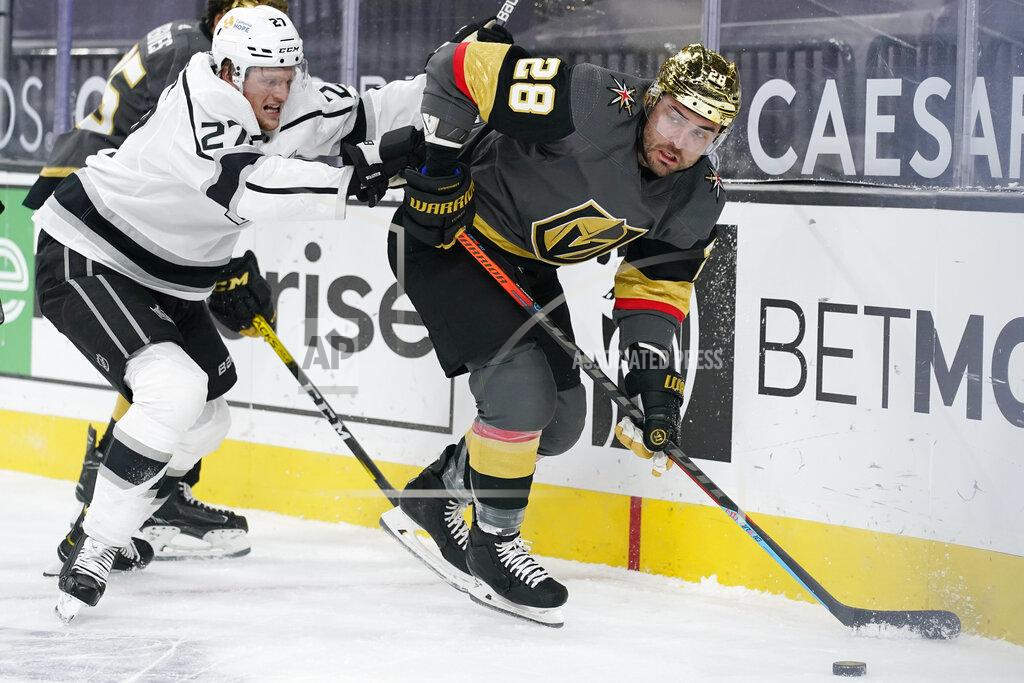 John Locher Vegas Golden Knights left wing William Carrier (28) passes around Los Angeles Kings left wing Austin Wagner (27) during the second period of an NHL hockey game Monday, March 29, 2021, in Las Vegas. (AP Photo/John Locher)